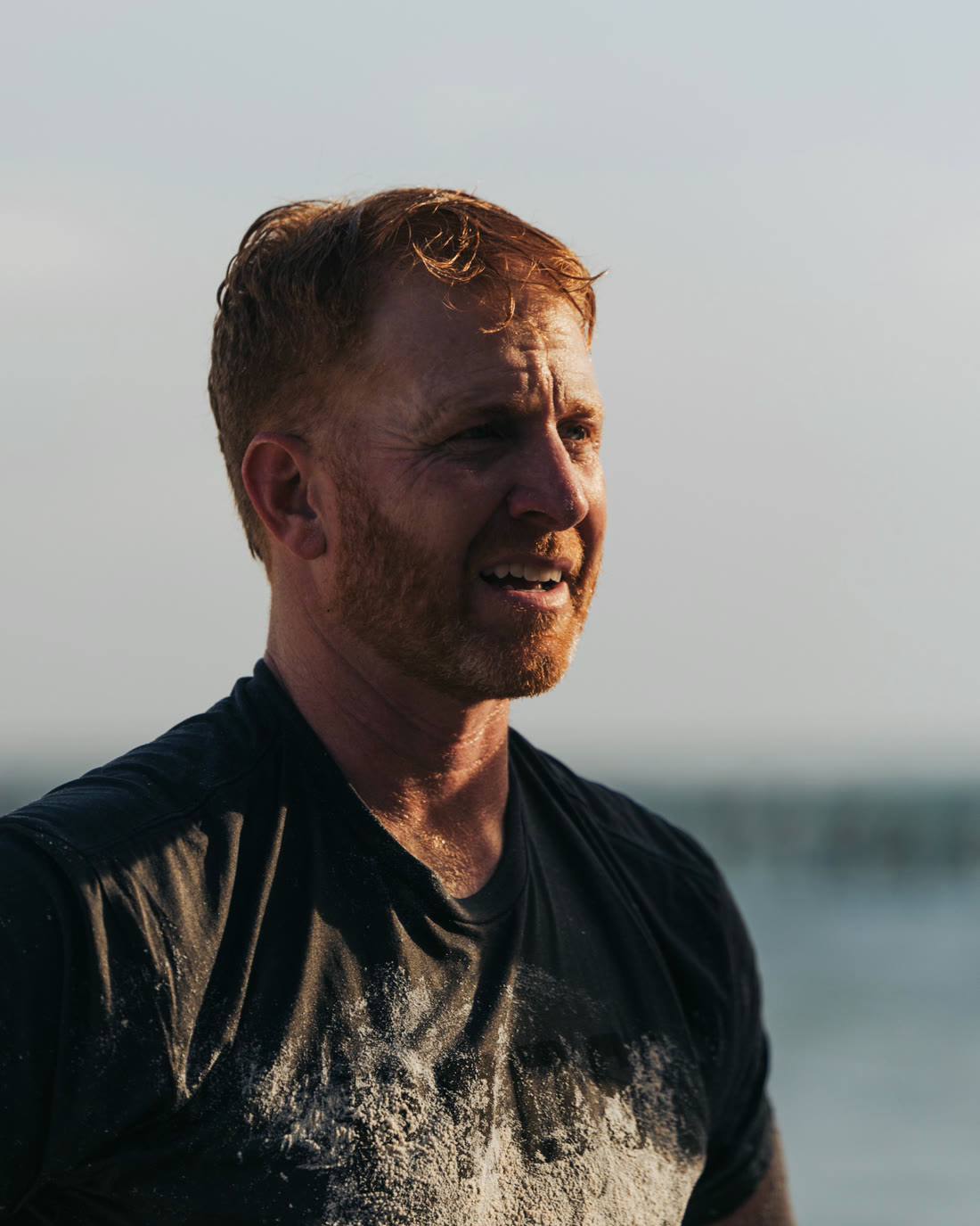 Man looking out at the water in soft light