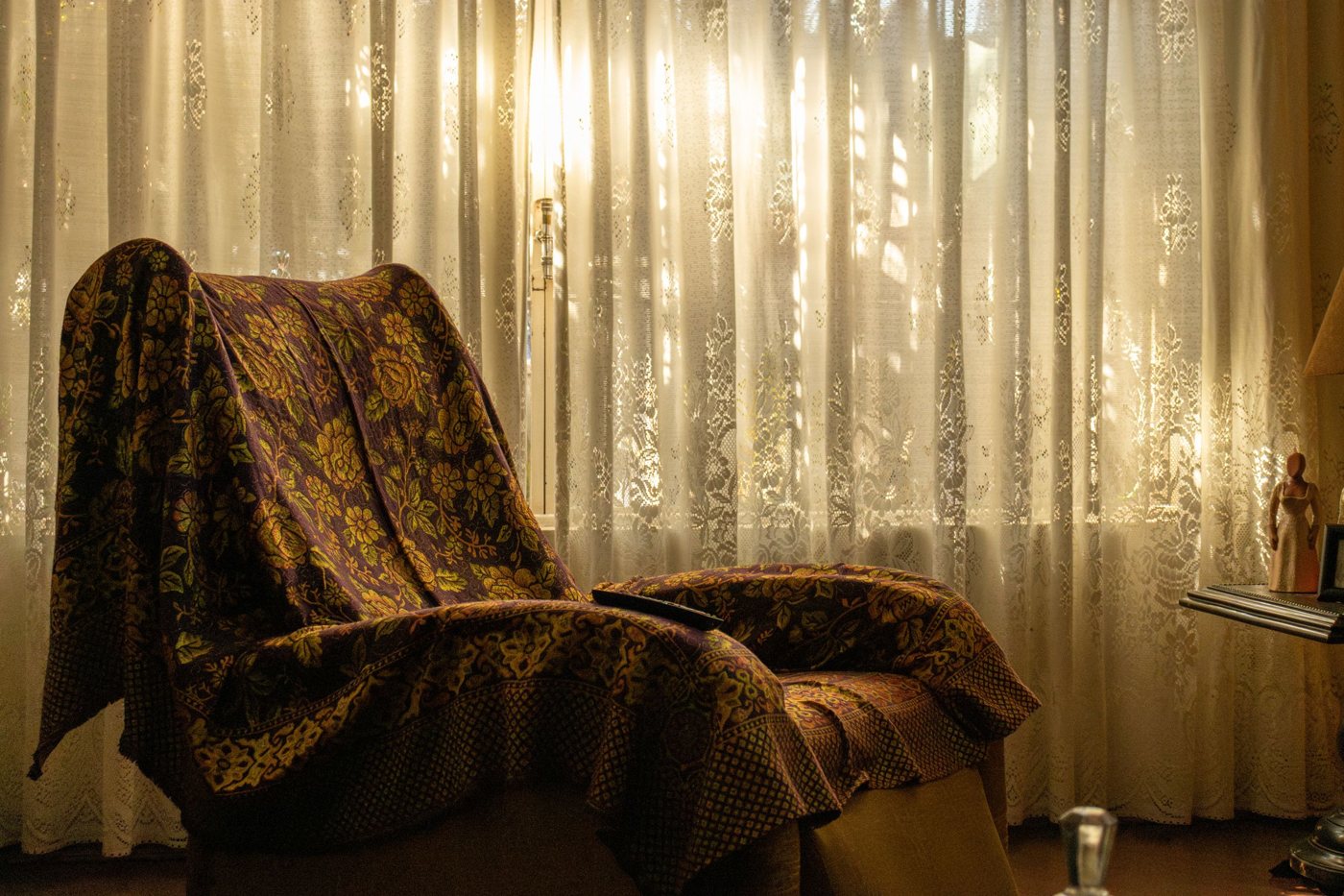Armchair by a curtained window